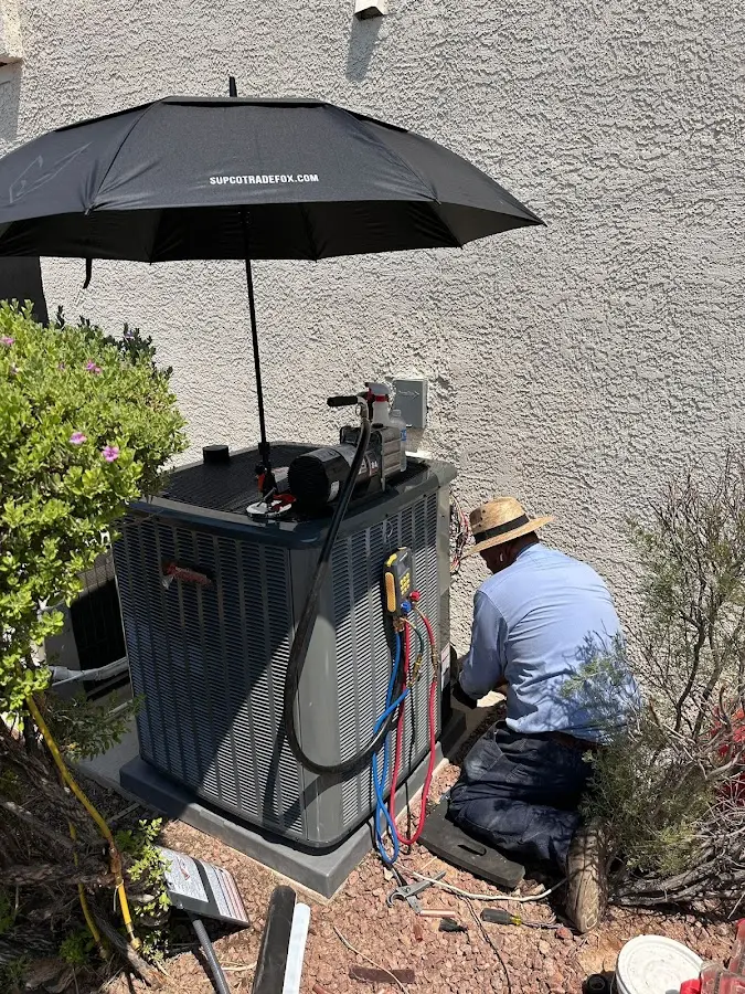 HVAC technician performing outdoor AC maintenance in Severance